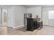 Bar area in basement featuring a rustic bar, barstools, wine glasses and a stainless steel refrigerator at 7823 E 130Th Pl, Thornton, CO 80602