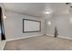 Large media room with neutral carpet and a large blank screen ready for movie nights at 7823 E 130Th Pl, Thornton, CO 80602