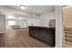 Spacious basement featuring wooden floors, a modern bar, and ample room for entertaining guests at 7823 E 130Th Pl, Thornton, CO 80602
