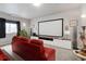 Home theater in basement with a large screen, comfortable seating, and modern decor at 7823 E 130Th Pl, Thornton, CO 80602