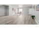 Finished basement area with wood flooring, seating area, and natural light from the window at 7823 E 130Th Pl, Thornton, CO 80602