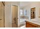 Bathroom featuring a soaking tub, tile accents, vanity sink, and a glass-enclosed shower at 7823 E 130Th Pl, Thornton, CO 80602