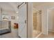 Bathroom with a glass enclosed shower, barn door, neutral tones and tile flooring at 7823 E 130Th Pl, Thornton, CO 80602