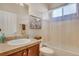 Well-lit bathroom with a vanity, neutral tiles, and shower-tub combination at 7823 E 130Th Pl, Thornton, CO 80602