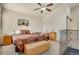 Bedroom with a ceiling fan, artwork, neutral walls and comfy patterned bedding at 7823 E 130Th Pl, Thornton, CO 80602