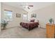 Bedroom featuring neutral carpet and walls, a ceiling fan, and bright windows overlooking the neighborhood at 7823 E 130Th Pl, Thornton, CO 80602