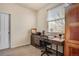 Bright room with a desk, chair, cabinets, and a large window providing natural light, perfect for a home office at 7823 E 130Th Pl, Thornton, CO 80602