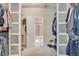 Walk-in closet featuring mirrored doors and ample shelving at 7823 E 130Th Pl, Thornton, CO 80602