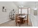 Elegant dining room with a large window, chandelier, and stylish shelving unit at 7823 E 130Th Pl, Thornton, CO 80602