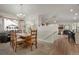 Open-concept dining area with hardwood floors, a staircase, and an abundance of natural light at 7823 E 130Th Pl, Thornton, CO 80602