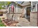 Inviting front entrance with brick accents, decorative plants, and a welcome sign at 7823 E 130Th Pl, Thornton, CO 80602