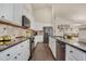 Modern kitchen featuring granite countertops, stainless steel appliances, and white cabinetry at 7823 E 130Th Pl, Thornton, CO 80602