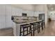 Spacious kitchen island featuring granite countertops, modern appliances, and breakfast bar seating at 7823 E 130Th Pl, Thornton, CO 80602