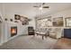 Comfortable living room with a cozy fireplace, neutral tones, and large window at 7823 E 130Th Pl, Thornton, CO 80602