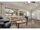 Bright living room features large windows, neutral decor, and comfortable seating at 7823 E 130Th Pl, Thornton, CO 80602
