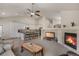 Bright, open living space with a fireplace, modern kitchen, and comfortable seating at 7823 E 130Th Pl, Thornton, CO 80602