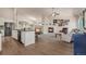 Open-concept living room featuring a fireplace, hardwood floors, and modern kitchen island at 7823 E 130Th Pl, Thornton, CO 80602