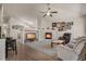 Spacious living room with a fireplace, comfortable seating, and a ceiling fan at 7823 E 130Th Pl, Thornton, CO 80602