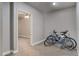 Functional room with carpet and a view into a bedroom, perfect for bike storage and other items at 7823 E 130Th Pl, Thornton, CO 80602