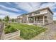 Lush backyard featuring a well-manicured lawn, a wooden fence, and a beautiful garden at 3162 Grizzly Peak Dr, Broomfield, CO 80023