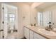 Bathroom featuring a double sink vanity with white cabinetry and a large mirror at 3162 Grizzly Peak Dr, Broomfield, CO 80023