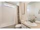 Clean bathroom featuring a shower-tub combo, white tile, and natural light from the window at 3162 Grizzly Peak Dr, Broomfield, CO 80023