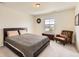 Comfortable bedroom with neutral carpet, a large bed, and a cozy armchair at 3162 Grizzly Peak Dr, Broomfield, CO 80023