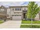 Beautiful two-story home with a well-manicured lawn and a two car garage on a sunny day at 3162 Grizzly Peak Dr, Broomfield, CO 80023