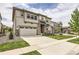 Inviting two-story home with a spacious driveway, lawn and attractive stone and siding accents at 3162 Grizzly Peak Dr, Broomfield, CO 80023