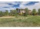 Beautiful home surrounded by mature trees and landscaping at 3162 Grizzly Peak Dr, Broomfield, CO 80023