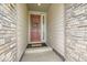 Charming entryway with a traditional wooden door, decorative wreath, and a welcoming stone facade at 3162 Grizzly Peak Dr, Broomfield, CO 80023