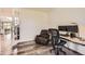 Well lit home office area with hard wood floors, desk, and leather reclining chair at 3162 Grizzly Peak Dr, Broomfield, CO 80023