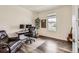 Comfortable home office space with wood floors, neutral walls, desk, and large comfortable reclining chair at 3162 Grizzly Peak Dr, Broomfield, CO 80023