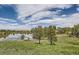 Scenic lake view with playground and grassy fields, perfect for outdoor activities and relaxation at 3162 Grizzly Peak Dr, Broomfield, CO 80023
