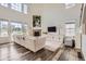 Bright living room with high ceilings, fireplace, lots of light and modern decor at 3162 Grizzly Peak Dr, Broomfield, CO 80023