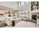 Open-concept living room with a large comfortable sectional and stylish furnishings, great for gathering at 3162 Grizzly Peak Dr, Broomfield, CO 80023