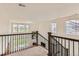 Bright loft area with views of the lower level, featuring large windows and a staircase at 3162 Grizzly Peak Dr, Broomfield, CO 80023