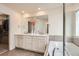 Bright primary bathroom showcasing dual sinks, vanity, soaking tub, and lots of lighting at 3162 Grizzly Peak Dr, Broomfield, CO 80023