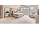 Bright primary bedroom with large windows, plush carpet, and a sitting area at 3162 Grizzly Peak Dr, Broomfield, CO 80023