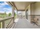 Covered patio with wood flooring, stone accents, and outdoor seating, perfect for relaxation at 3162 Grizzly Peak Dr, Broomfield, CO 80023