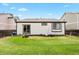 Large, grassy backyard featuring a swing set and patio doors at 13983 E 104Th Pl, Commerce City, CO 80022
