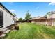 Spacious backyard with lush green lawn and wood privacy fence at 13983 E 104Th Pl, Commerce City, CO 80022