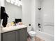 Neutral bathroom with a shower-tub, a vanity, and a black shower head at 13983 E 104Th Pl, Commerce City, CO 80022