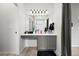 Neutral bathroom with a wide countertop, vanity, storage cabinets and a large mirror at 13983 E 104Th Pl, Commerce City, CO 80022