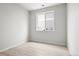 Simple bedroom with a large window and hardwood floors at 13983 E 104Th Pl, Commerce City, CO 80022