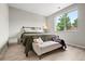 Bright bedroom featuring a large window, light-colored wood floors and a comfy bench at 13983 E 104Th Pl, Commerce City, CO 80022