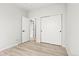 Simple bedroom featuring an open closet and wood-look floors at 13983 E 104Th Pl, Commerce City, CO 80022