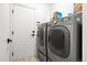 Functional laundry room with modern side-by-side washer and dryer units at 13983 E 104Th Pl, Commerce City, CO 80022