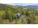 Mountain home surrounded by lush greenery and mature trees in a picturesque setting at 11222 Conifer Mountain Rd, Conifer, CO 80433