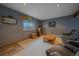 Basement living room with a window, wood accents, and comfortable seating at 11222 Conifer Mountain Rd, Conifer, CO 80433